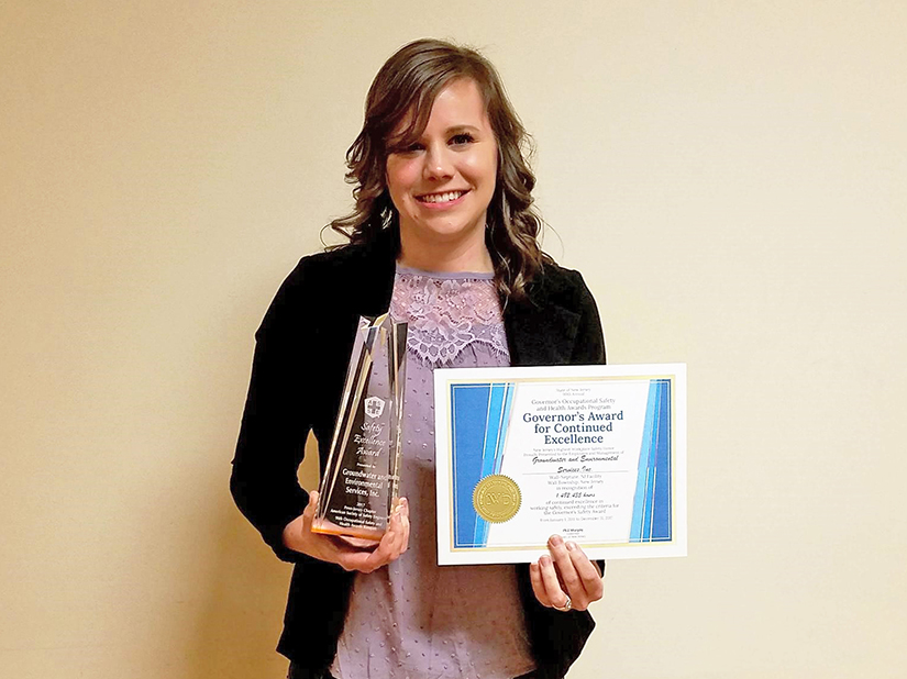 Kara Gioulis, Regional HSSE Officer posing with awards