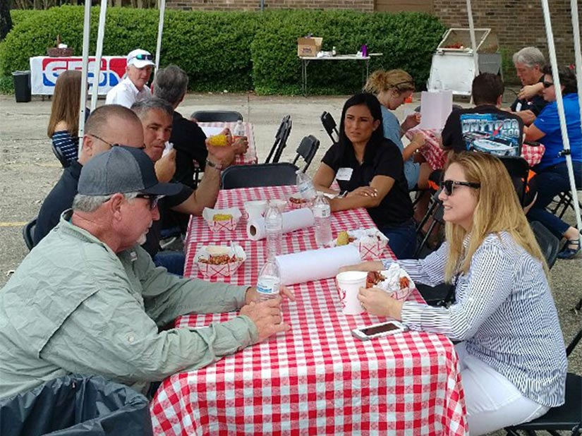 People eating at a picnic table