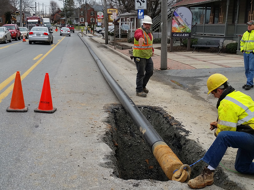Water supply pipeline installation in downtown streetscape